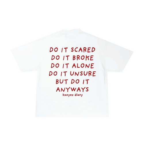 White crew neck t-shirt with text 'DO IT SCARED DO IT BROKE DO IT ALONE DO IT UNSURE BUT DO IT ANYWAYS' in red on the back.